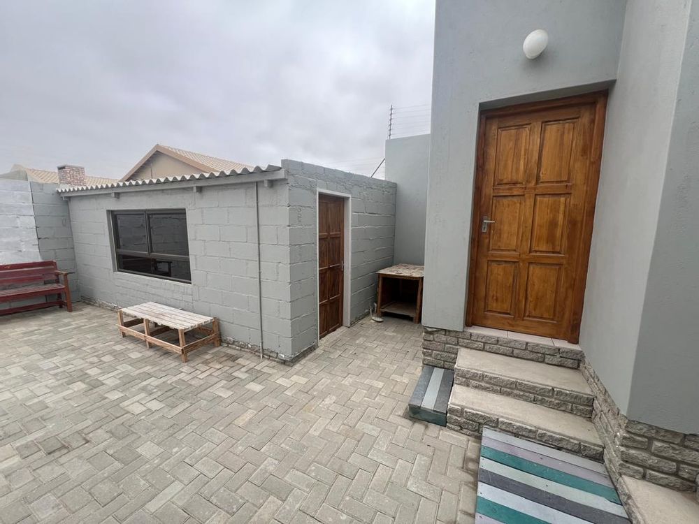 Back courtyard with entertainment room and staff WC