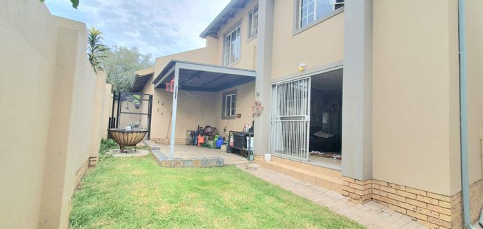 For Sale: Townhouse in Ruimsig Country Estate with garden, double garage, and en-suite.