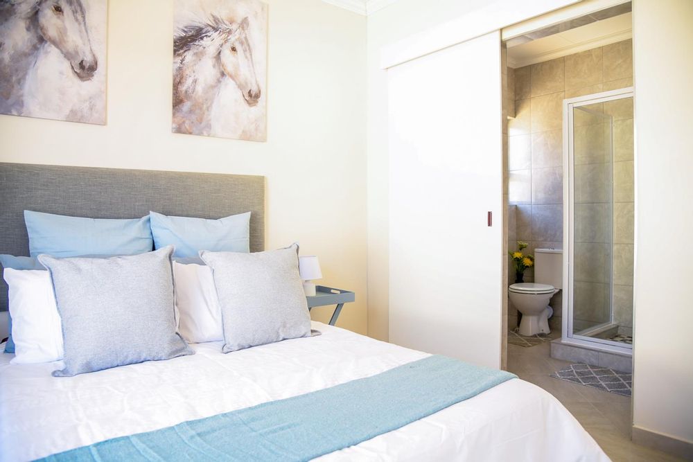 Main bedroom with built-in cupboards and ensuite bathroom.