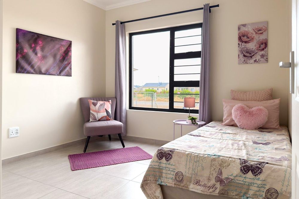 Second bedroom with built-in cupboards.