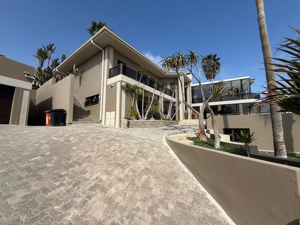 House seen from the entrance gate. Double garage to the left