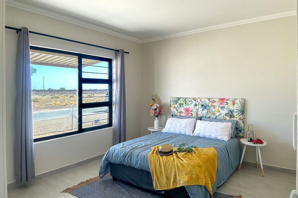 Spacious main bedroom with built-in cupboards.