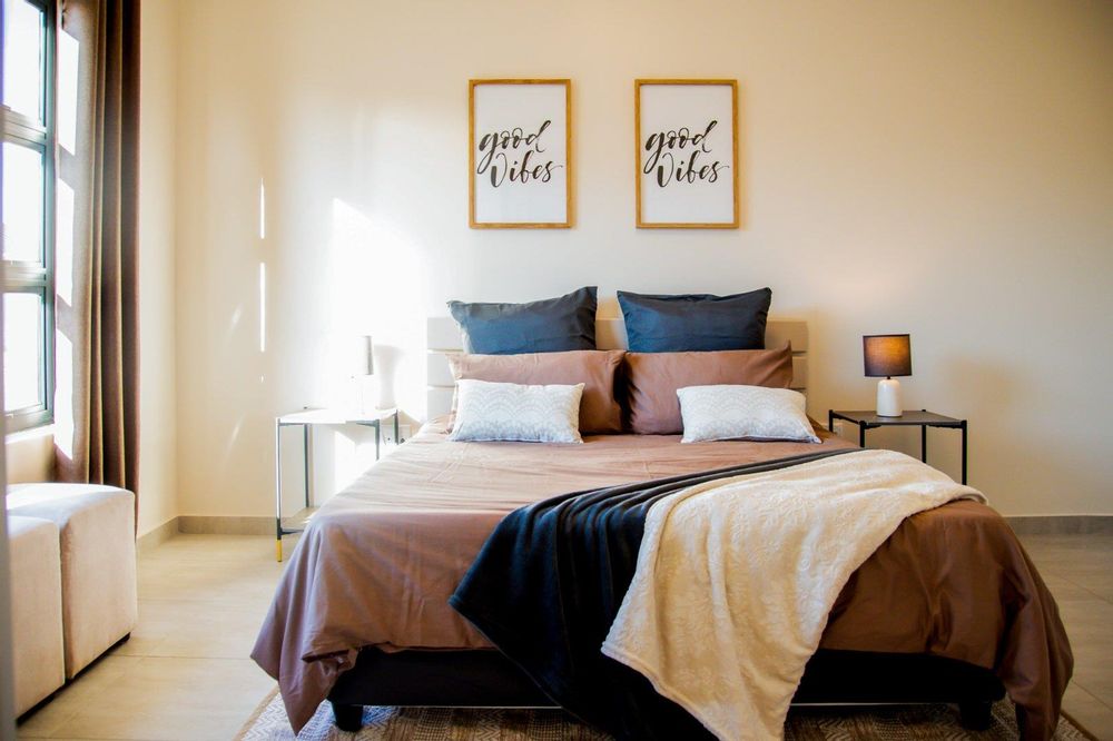 Main bedroom with built-in cupboards and ensuite bathroom.