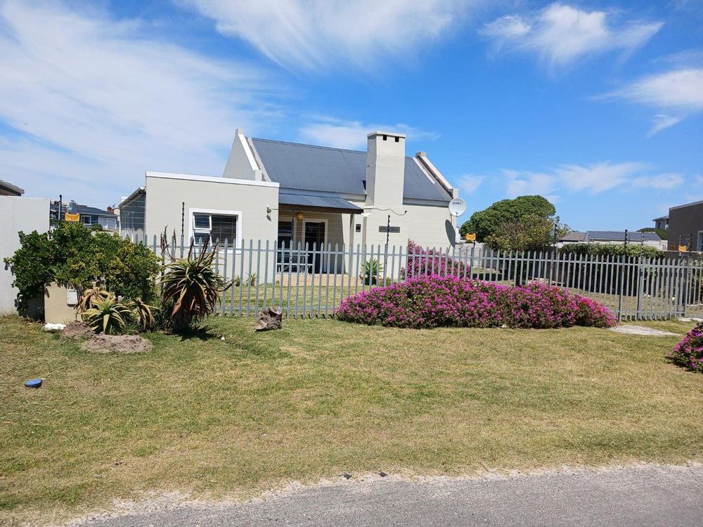 Front View of House - as from the Street. Palisade in front - and Electric Fencing on 4 sides.