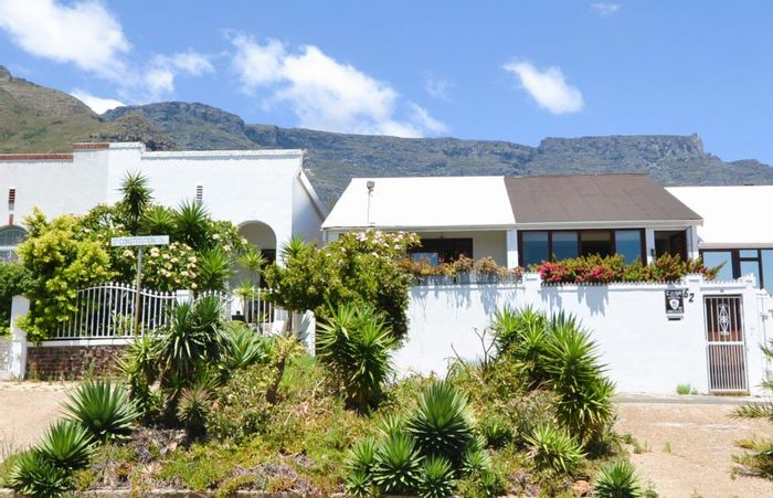 Zonnebloem House For Sale: Two bedrooms, courtyard, sea views, and garage access.