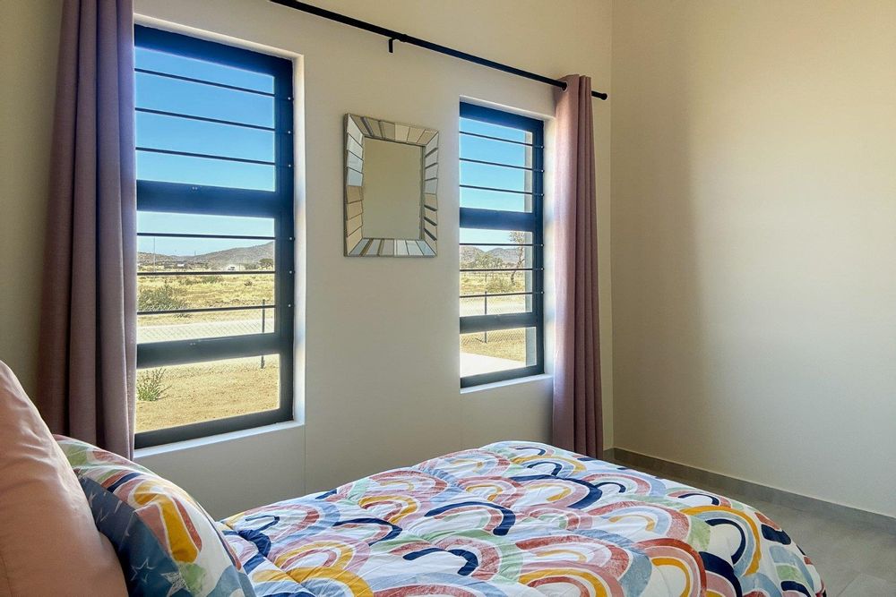 Spacious third bedroom with built-in cupboards.