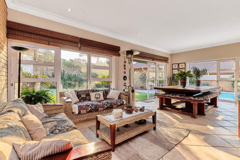 Entertainment room with sliding doors to the garden and pool