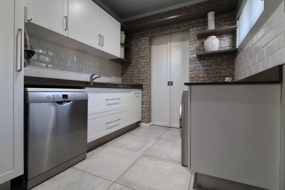 Scullery/laundry with access to pantry.