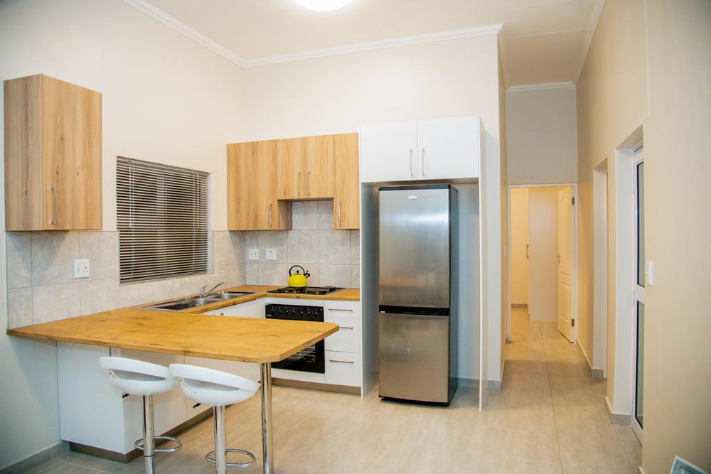 Kitchen with built-in cupboards and built-in stove.