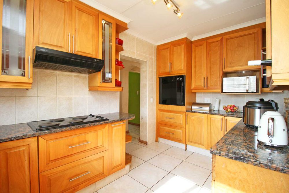 Kitchen with granite countertops that are a durable and heat resistant natural stone that resists scratches, chips and cracks making it ideal for a high-traffic family kitchen.