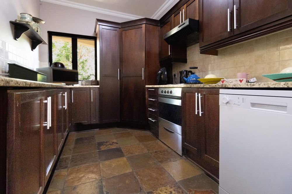 Kitchen with mahogany veneer cupboards and granite worktop
