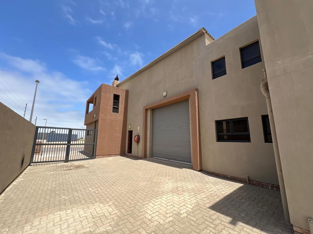 Side entrance 1 and sliding roller door leading to main dwelling 
