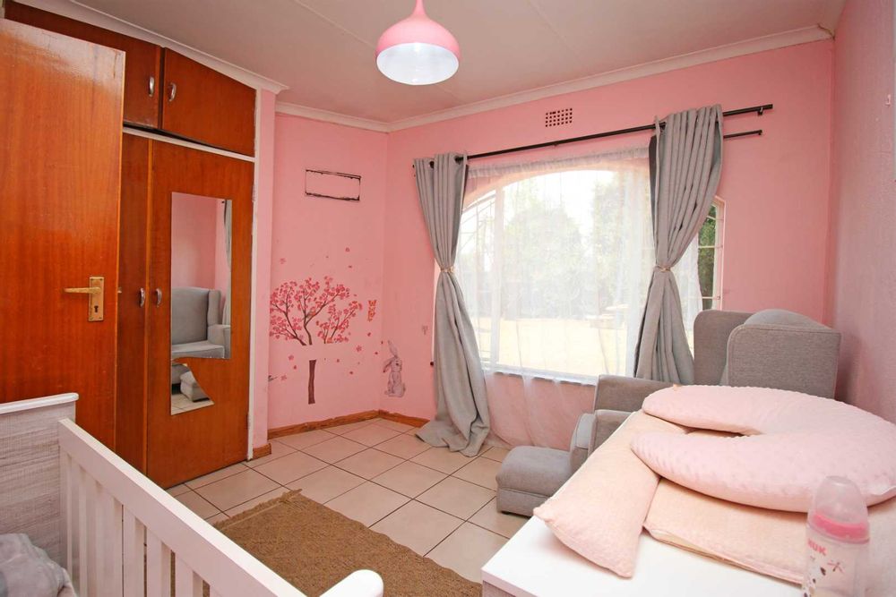 Bedroom 3 : The Nursery with Baby Cot, Baby Compactum Unit and Wing Back Armchair and matching Ottoman, with Built-In Cupboards and Tiled Floors