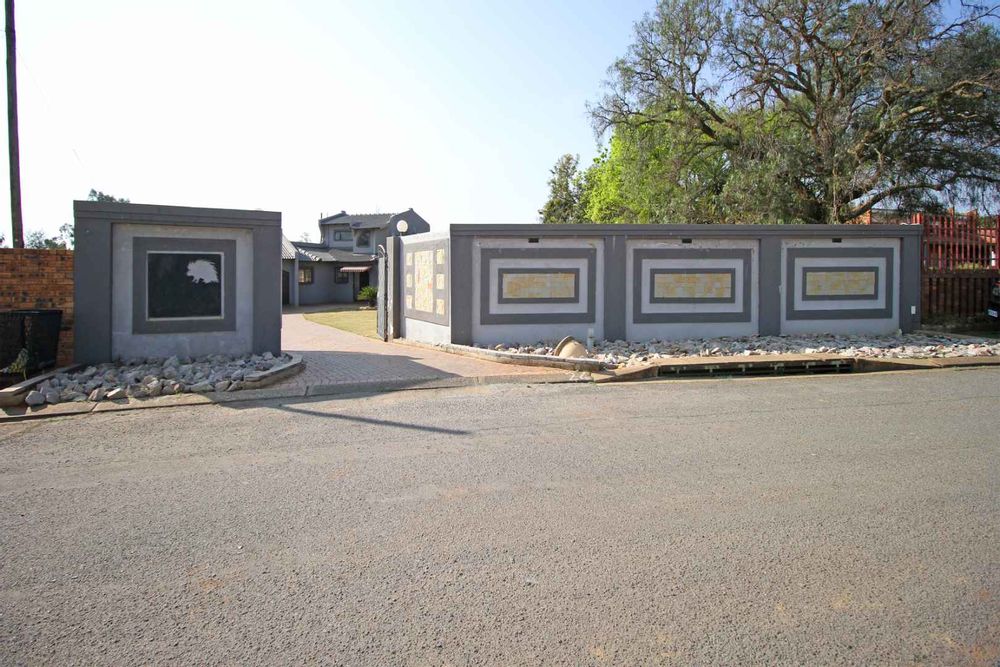The newly built Exterior Fence enhances the property's aesthetic appeal with its modern design, and double automated gates. A decorative element is the natural stone paver feature used in landscaping on the pavement.