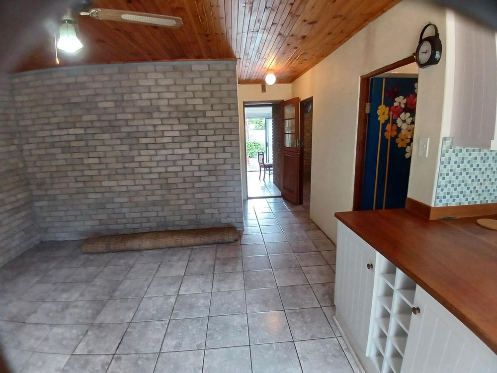 Living Area, Kitchen (on our right), front door and BBQ Room (right at the back).