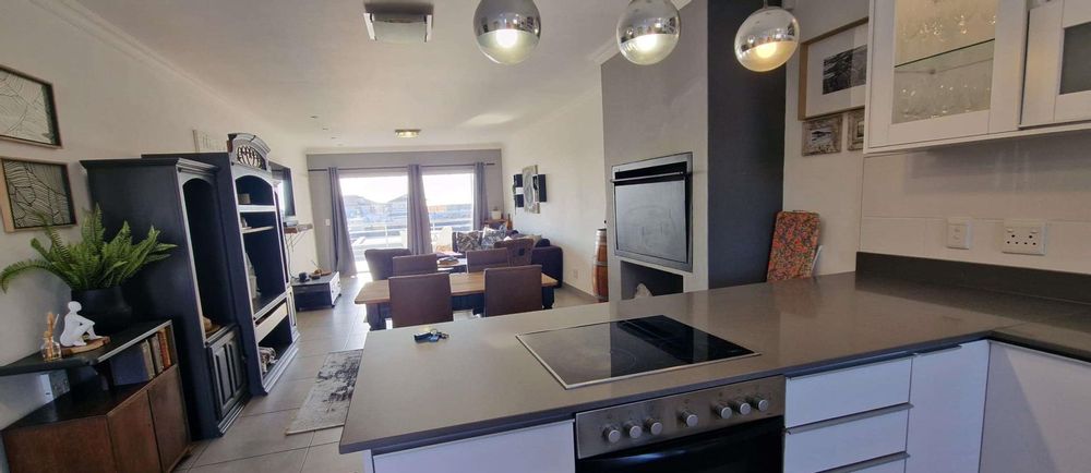 Open plan with dining area with indoor braai and tv area