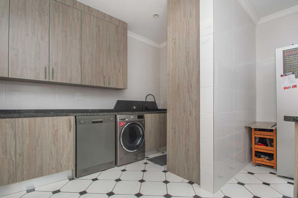 Tucked away cleaning area with space for two wet appliances