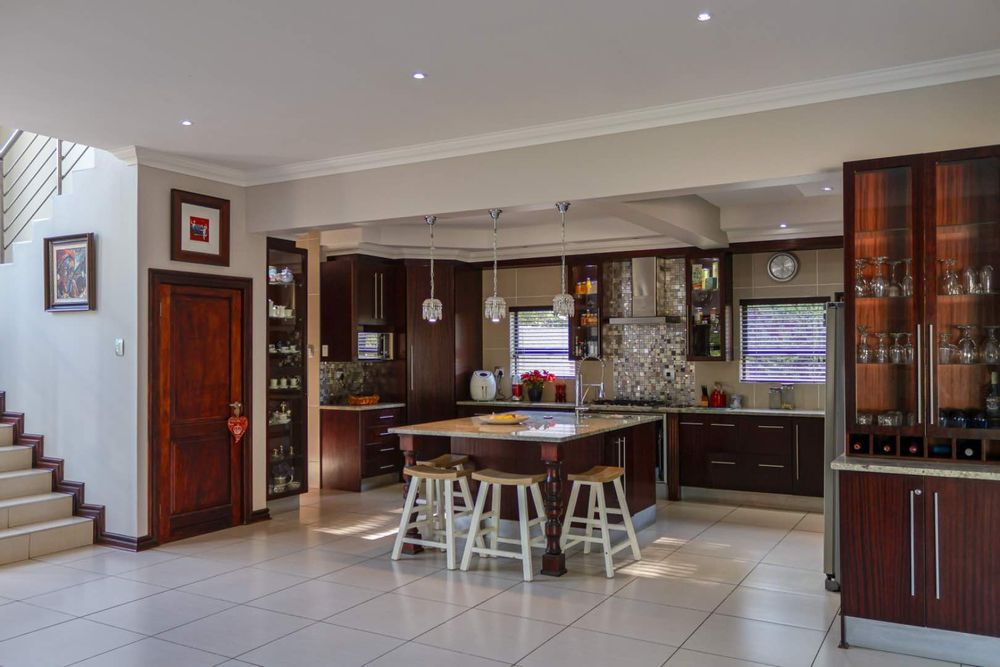 Open-plan mahogany kitchen with separate scullery/laundry area