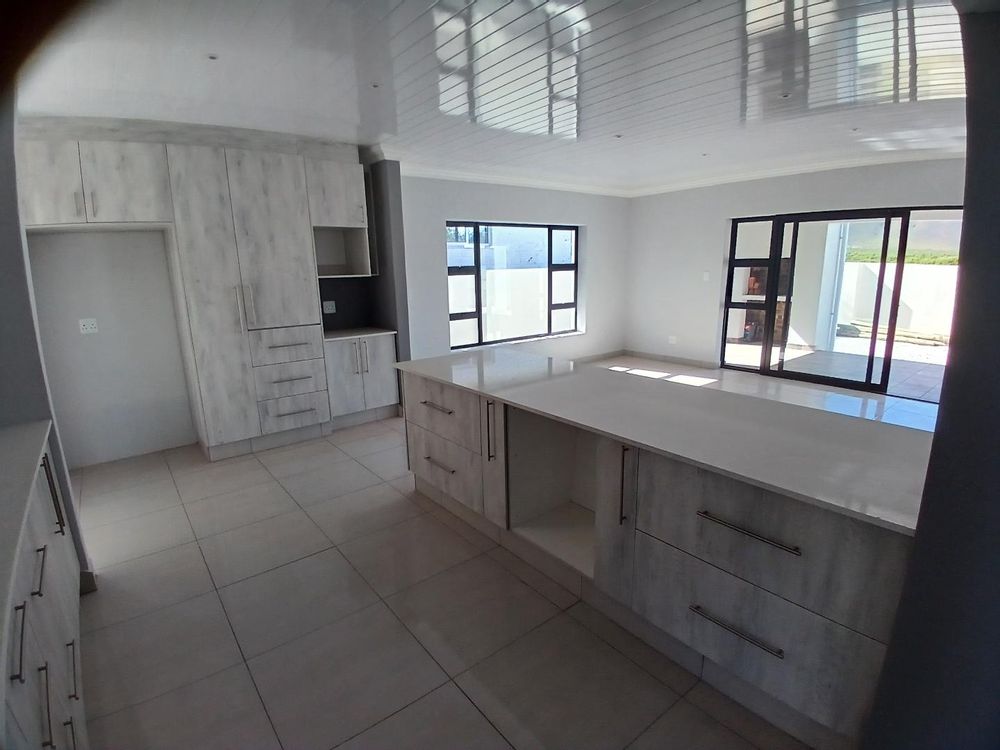 Main Living Area at back (and outside BBQ Area - at the back) - as from Kitchen.