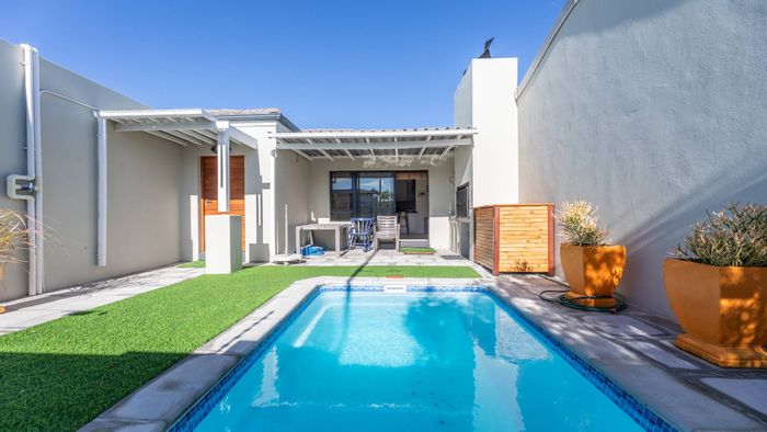 For Sale: 3-Bedroom House in Parklands North with pool, garage, and solar panels.