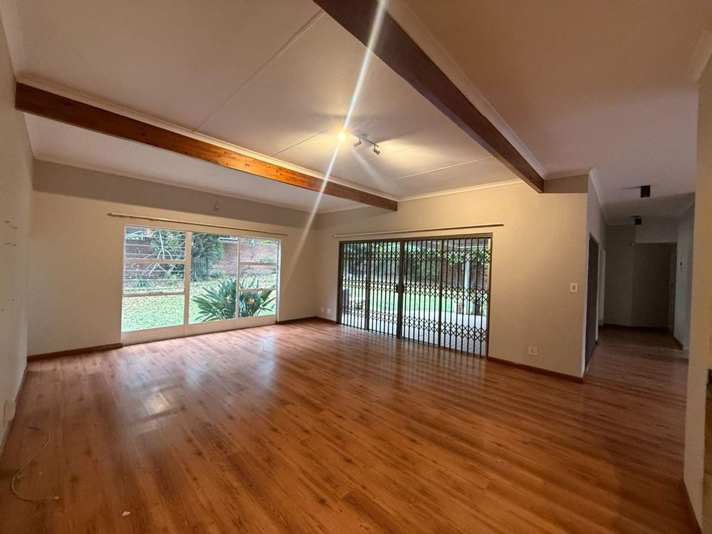 Huge lounge with sliding door leading to covered patio 
