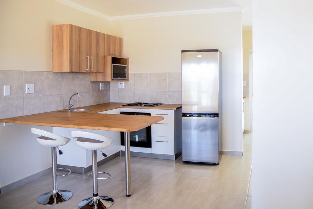Modern kitchen with plenty of cupboards and separate, kitchen scullery.