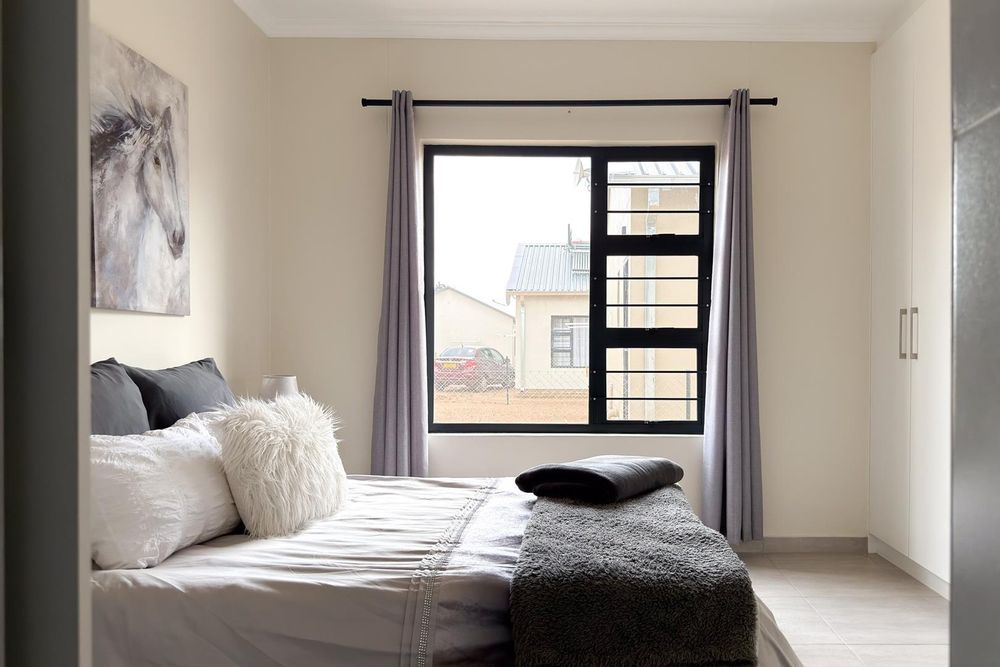 Main bedroom with built-in cupboards and ensuite bathroom.