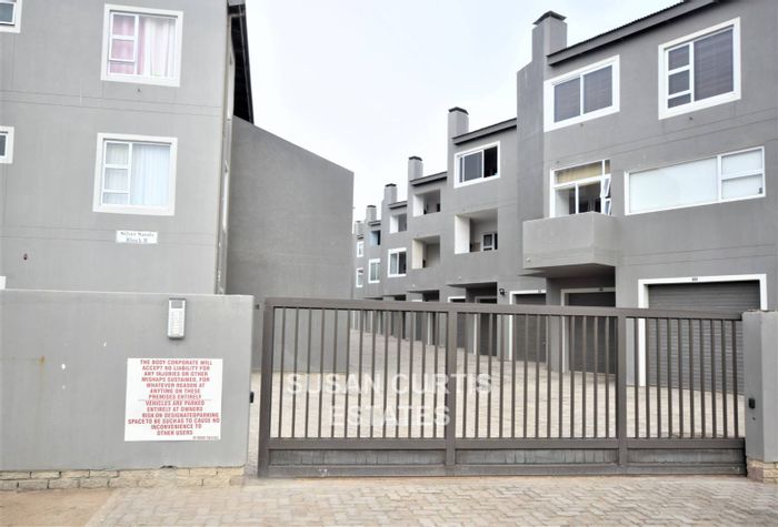 For Sale: Mile 4 Apartment with 2 Bedrooms, Balcony, Garage, and Beach Access.