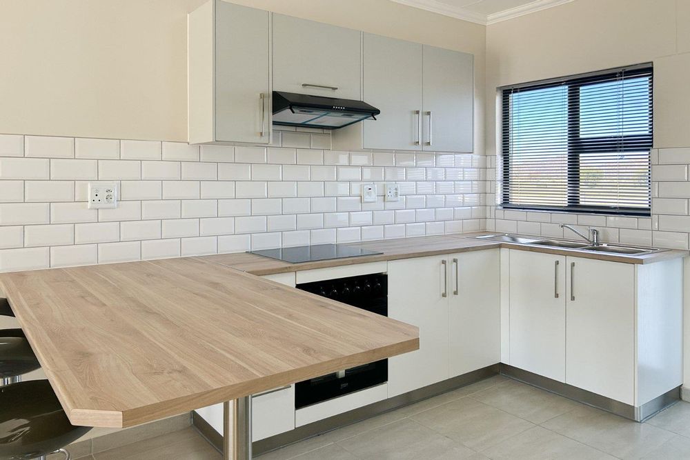 Kitchen with built-in cupboards & oven.