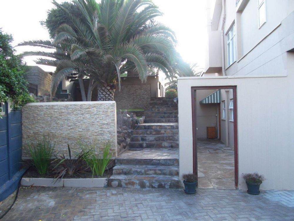 Stair case to main house entrance and to the right entrance to the flat on ground floor