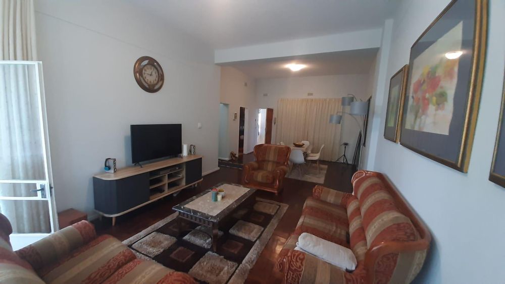 Lounge area leading to enclosed verandah and view of dining room
