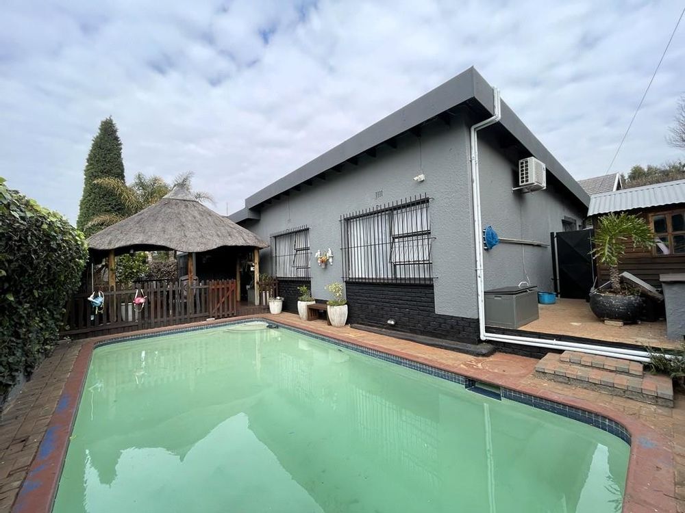 Solar heated pool with a cover