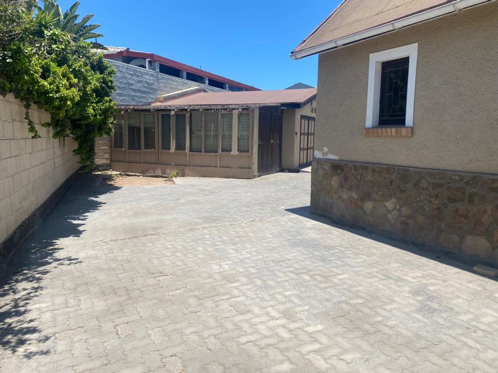 Side entrance to the property leading to the flat and 2 more garages