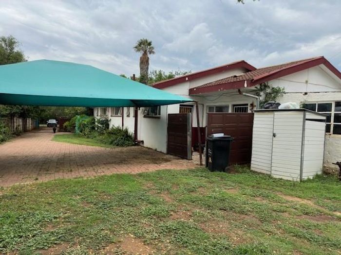 Spacious 4-bedroom house with cottage, braai area, and rental income in Lichtenburg Central. For Sale.