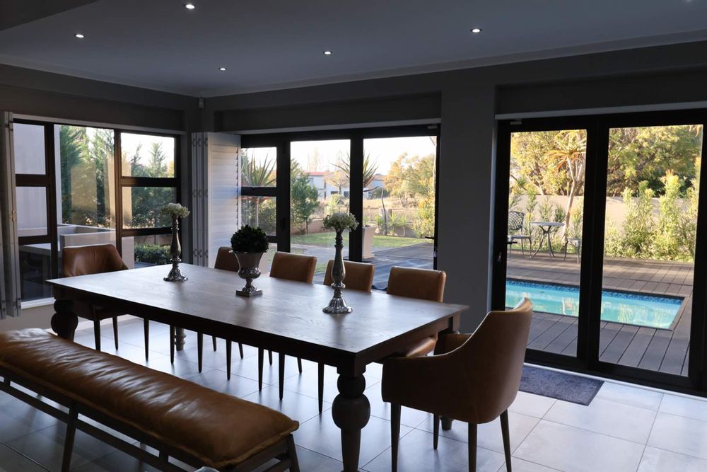 Dining area with sliding doors to pool and garden