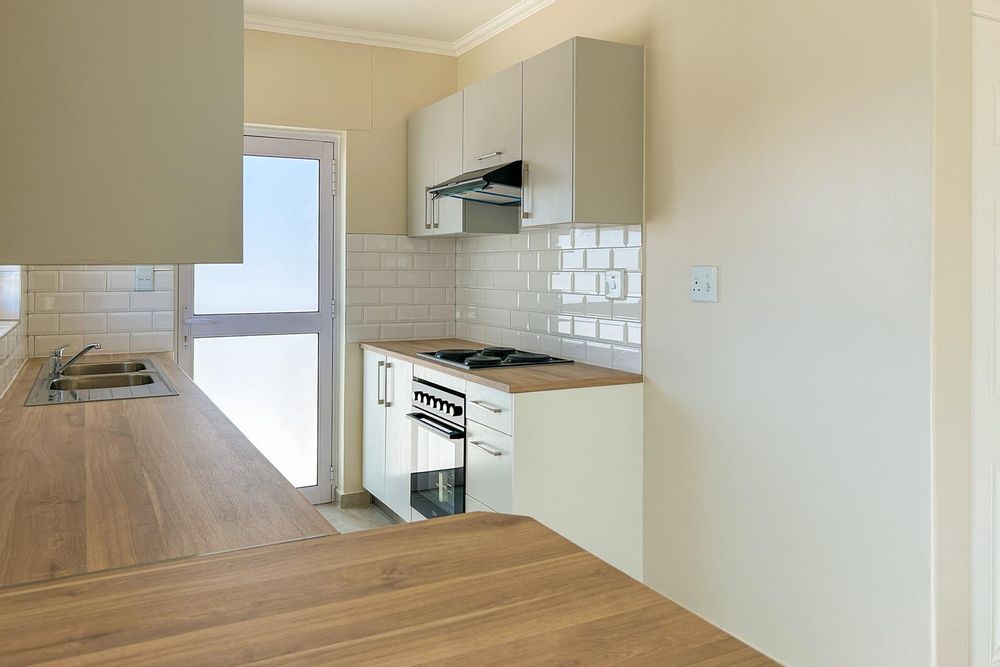 Modern kitchen with built-in cupboards and built-in oven.