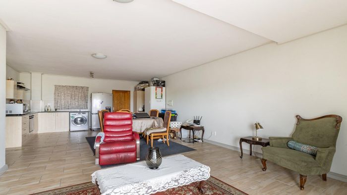 For Sale: Apartment in Milnerton Central with two bedrooms, balcony, and open-plan living.