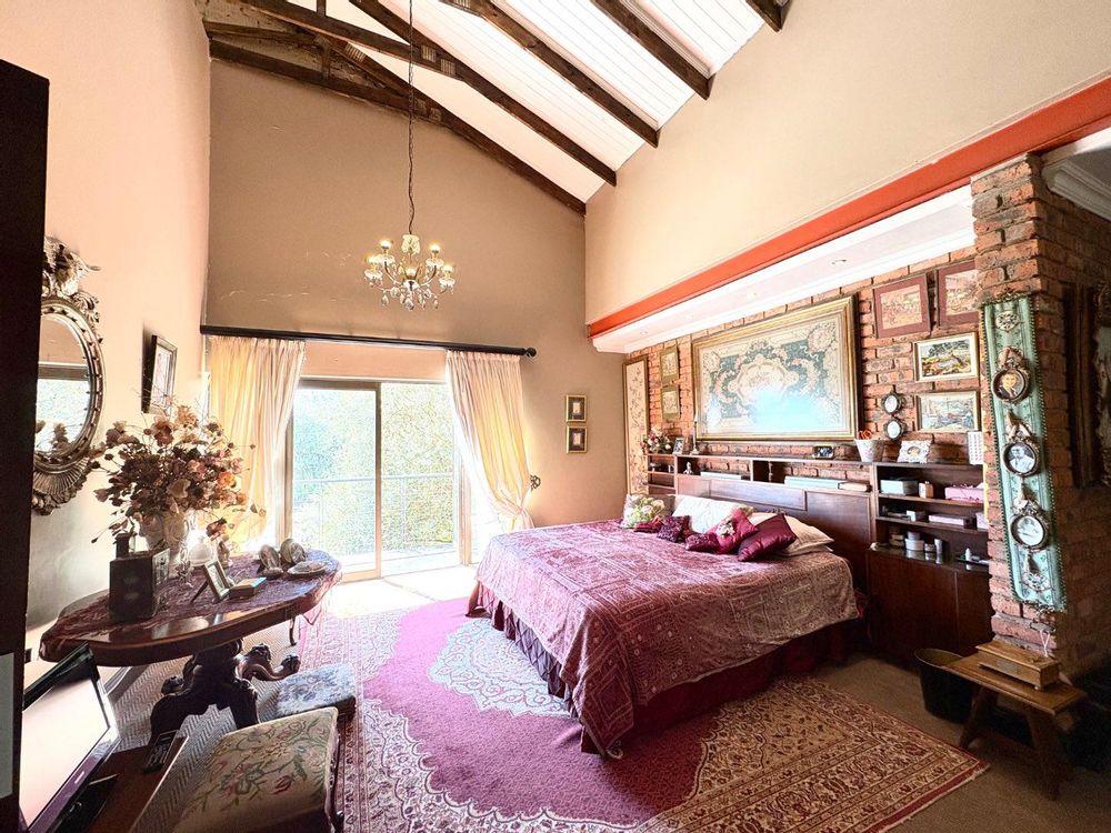 Main bedroom with sliding doors opening onto a balcony overlooking the green belt.