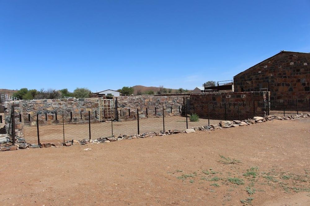 Picture of a fenced off area next the the brick building