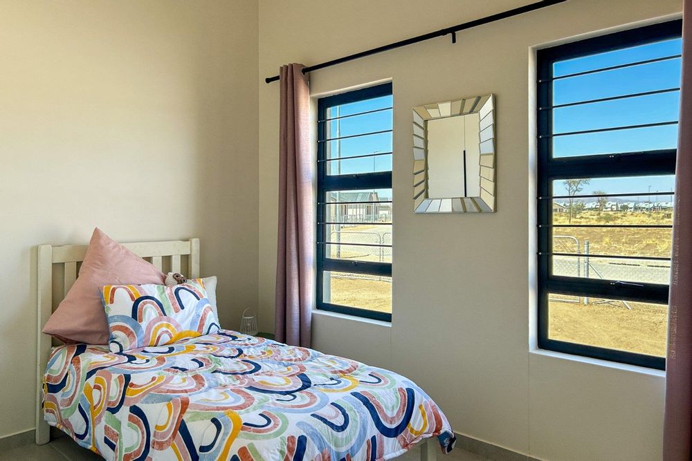Spacious third bedroom with built-in cupboards.