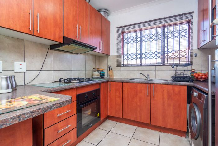 Two-bedroom townhouse for sale in Groblerpark Ext 9 with private garden and secure parking.