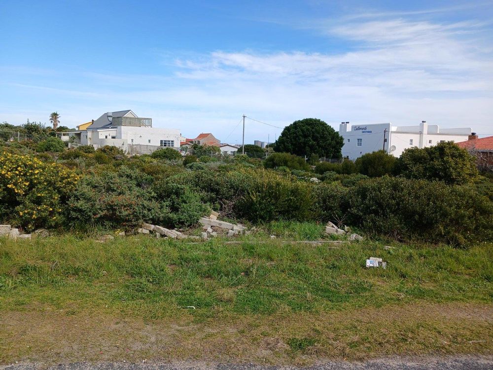 Our Plot in front of us. Restaurant on our left & a block of Flats on our right.