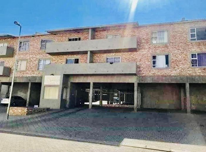 For Sale: Otjomuise Apartment with 2 bedrooms, open-plan kitchen, and living area.