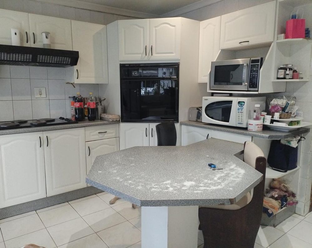 Kitchen with breakfast area, stove, extractor fan and eye level oven