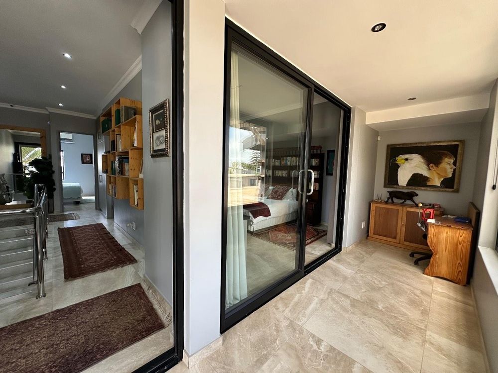 First floor with spare room and hallway to office