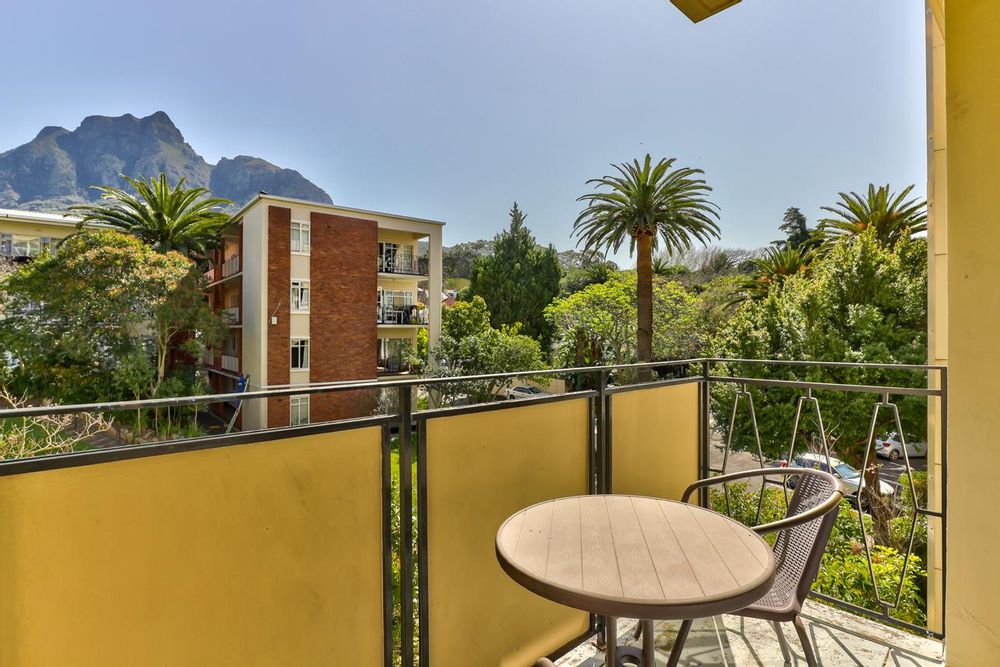 Balcony with mountain and garden views