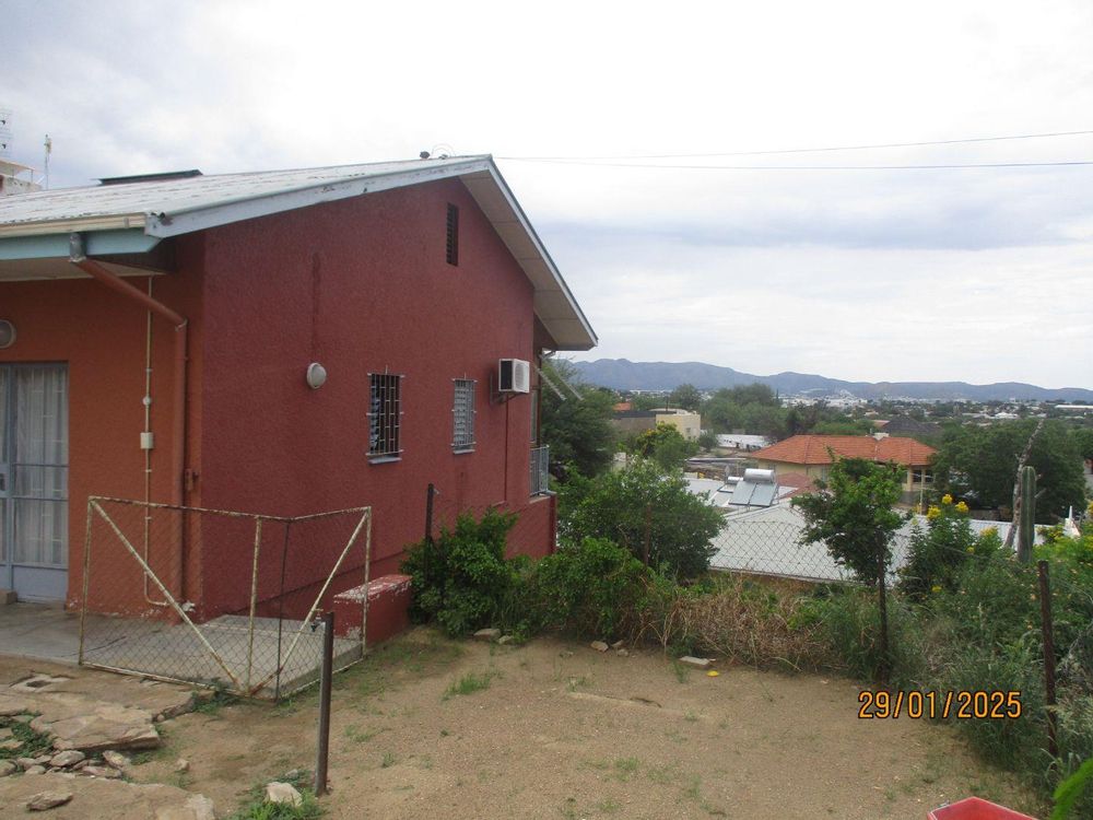 General view towards the side of the property, with the main bedroom equipped with a split unit air-conditioner. 