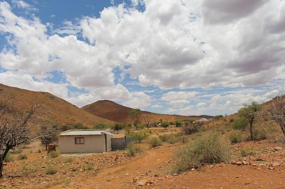 Gravel road and bricked building leading to the farm houses