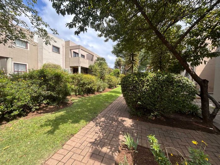 Townhouse For Sale in New Market Park: Pool, clubhouse, tennis court, and gardens.