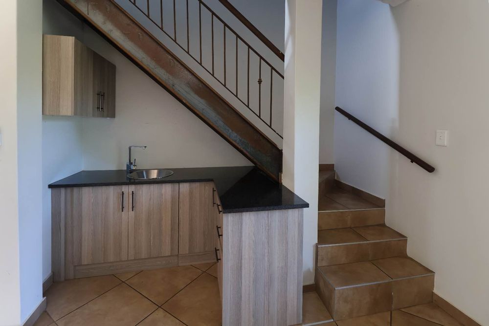Flatlet kitchenette and staircase to bedroom